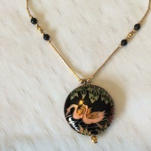 Black cloisonné necklace on gold chain.